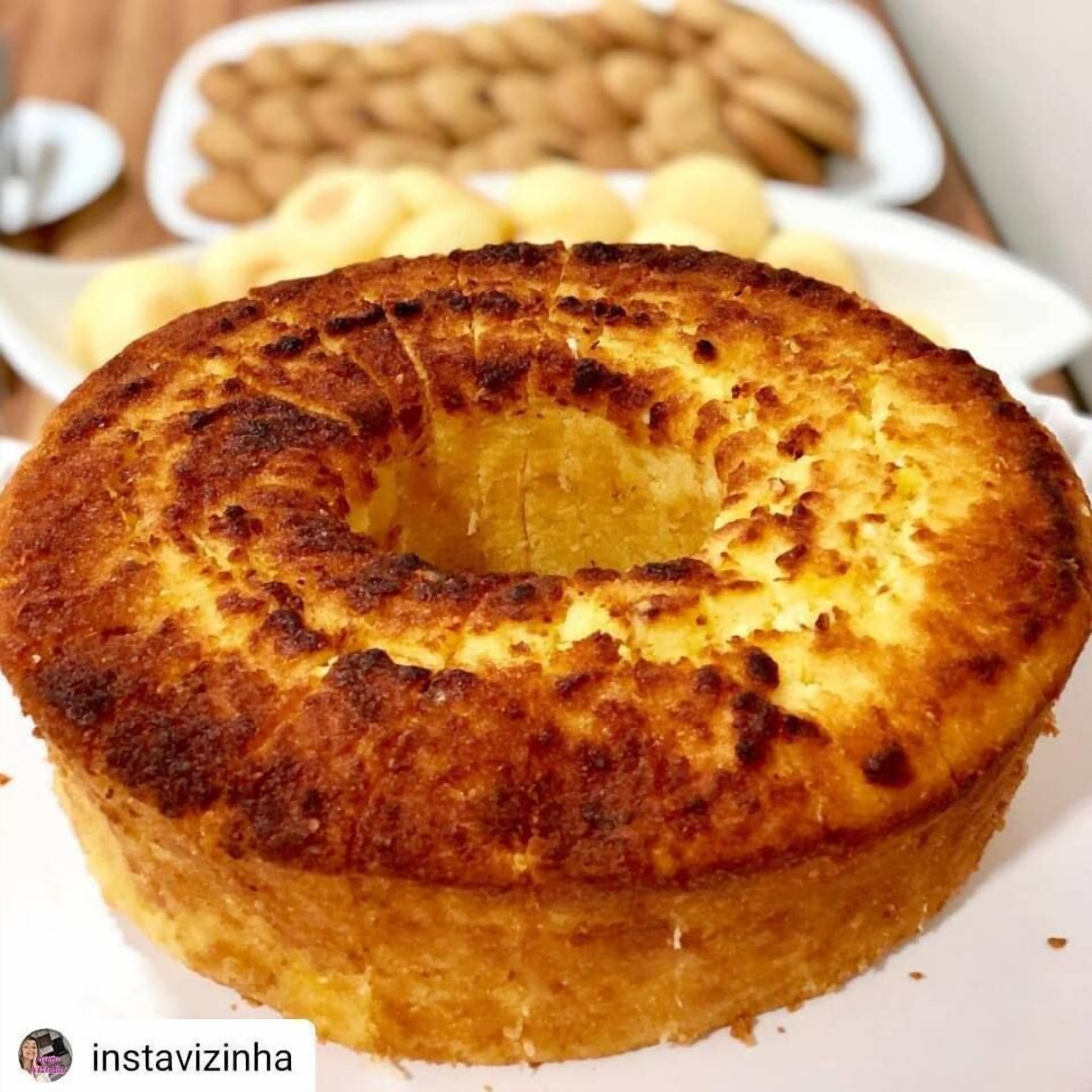 A round cake with a golden-brown crust, served on a white plate.