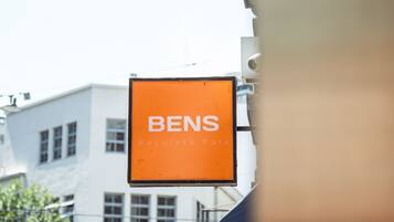 A sign for "BENS Recoleta Park" with a building in the background.