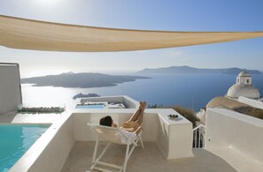 Relax in a tranquil oceanfront setting with a pool and serene views of the sea and distant islands.