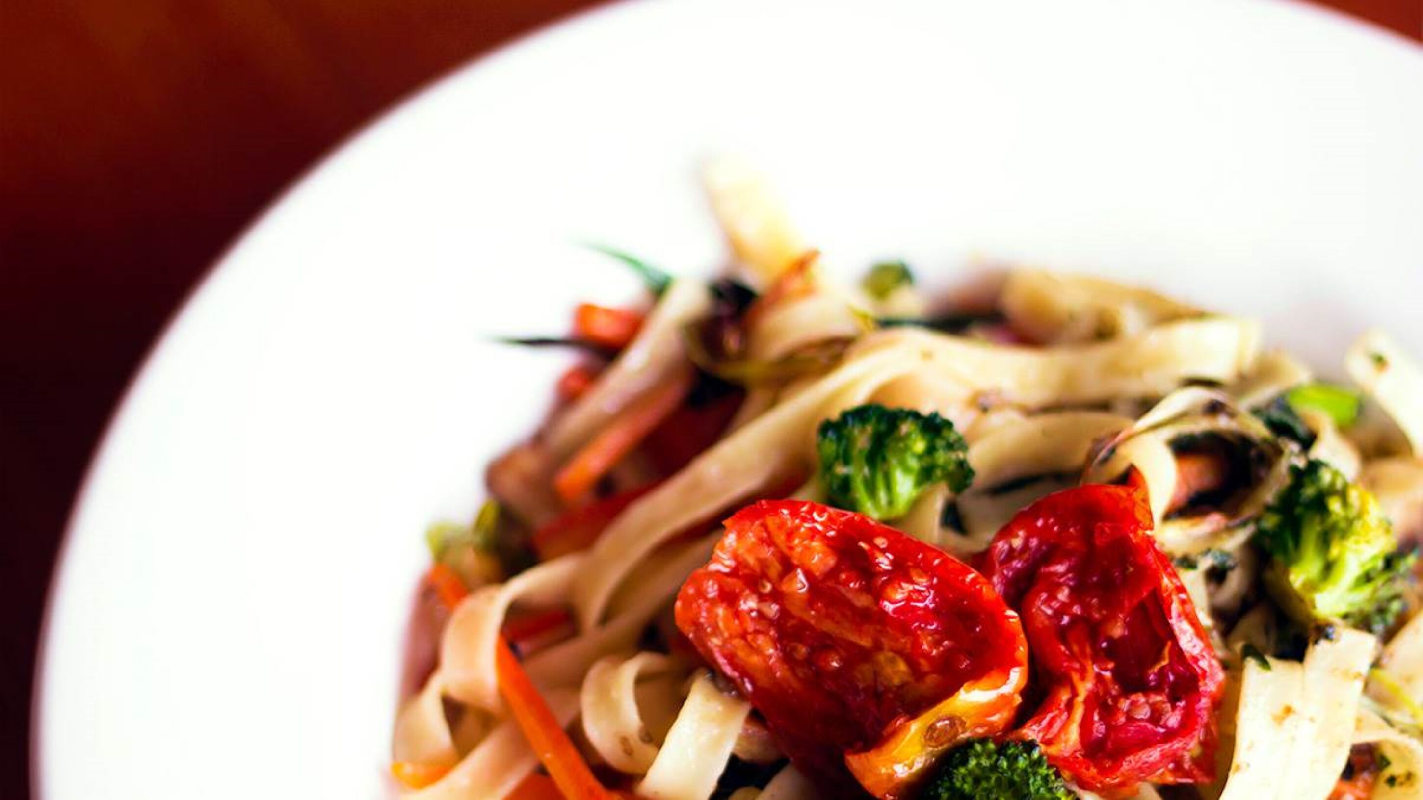 A plate of stir-fried noodles with vegetables.
