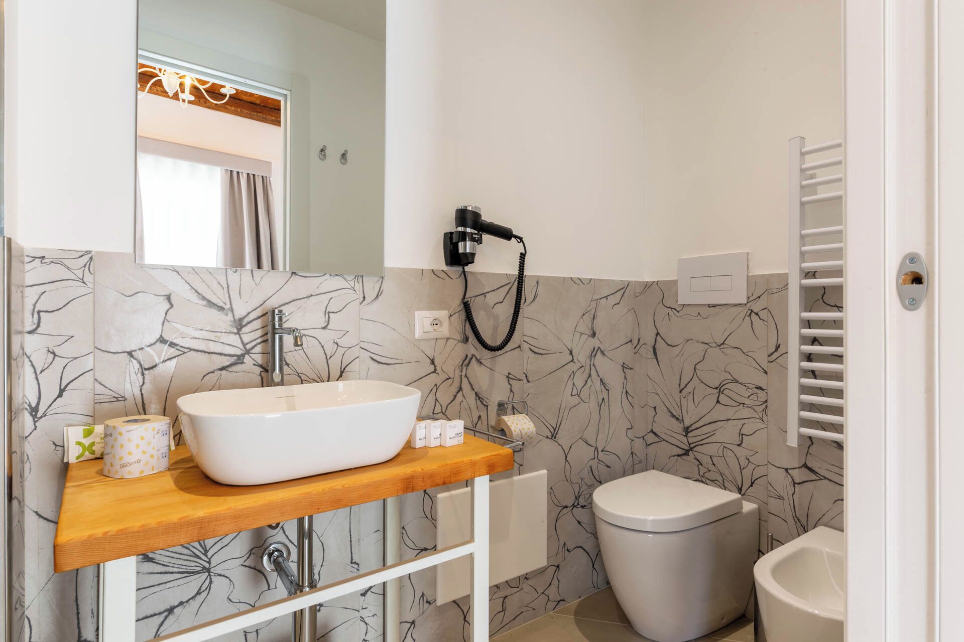 A bathroom with a white sink, toilet, and shower.