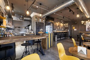 A modern café with a bar area, stools, and a menu board. - Hostel Urban (Minsk)