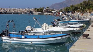 A marina with several boats docked, including a Yamaha boat. - Studio with sea view (Kokkinos Pirgos)
