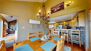 A cozy interior with a dining area, kitchen, and living space.