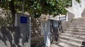 A stone staircase leading to a building entrance, a sign indicating an apartment, and a door with a number plate. - Stuck in the Moment Apartment - One Bedroom Apartment with Terrace and Sea View (Dubrovnik)
