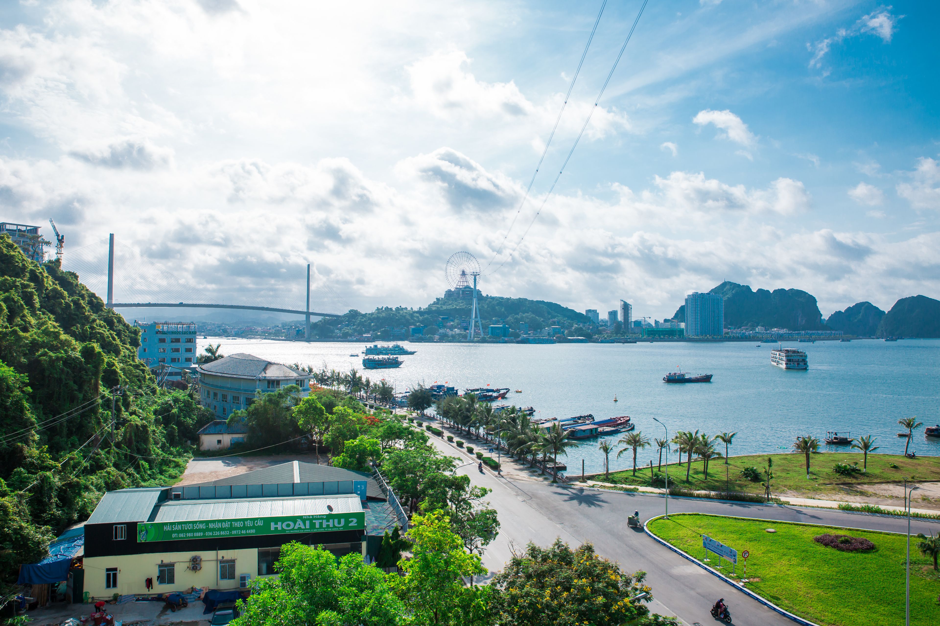 A coastal cityscape with a prominent building labeled "HOAT THU 2" and a view of the sea with boats.