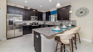 Stovetop, dishwasher, cookware/dishes/utensils - 6BR ChampionsGate Pool Home (Davenport)