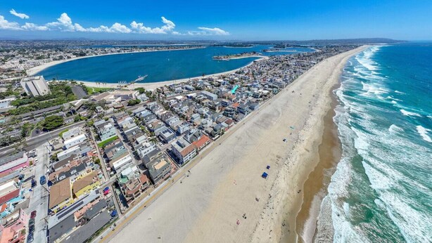 An aerial view of a coastal city with a long beachfront, dense residential area, and a marina. - Ben`s Beach Bungalow 2, 100 Steps to Sand (San Diego)