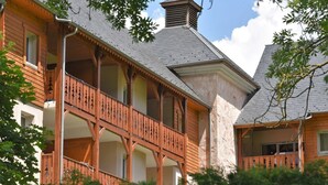 A wooden building with a balcony and a stone facade. - Residence Val de Roland - Studio Apartment 2 persons (Luz-Saint-Sauveur)