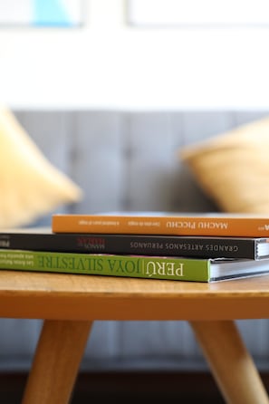 A stack of books on a wooden table. - 70's Rock Themed Apartment near Malecón de Miraflores (Lima)