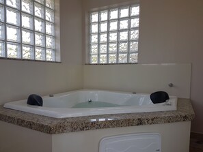Bathroom features a bathtub and granite countertop.
