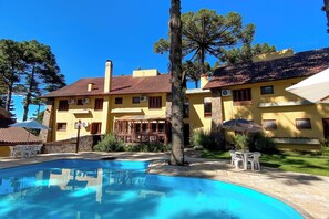 Ein gelbes Gebäude mit Pool und Außenbereich.