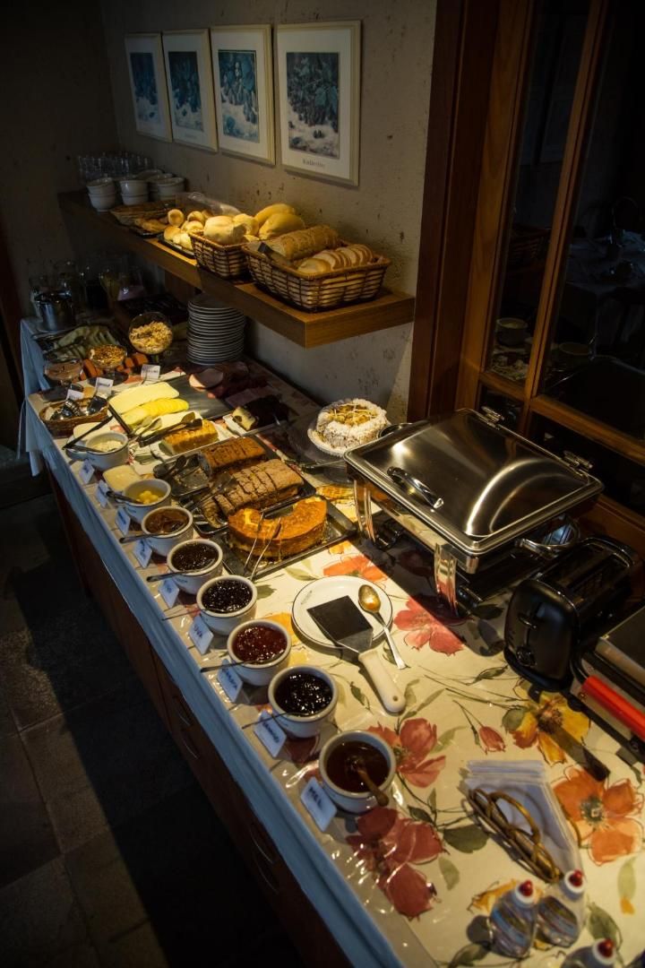 A buffet setup with various food items and condiments.