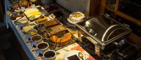 A buffet setup with various food items and condiments.