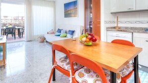 A modern apartment with a dining area, a kitchen, and a balcony with outdoor seating. - Fleming by Interhome (Lloret de Mar)