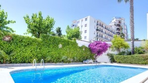 A swimming pool with a clear blue water surface, surrounded by a white pool deck. - Fleming by Interhome (Lloret de Mar)