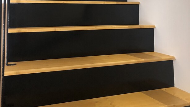 A staircase with black steps and wooden handrails. - THE THIRD RIVER OF ORNANS (Ornans)