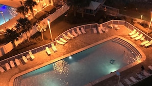 An aerial view of a swimming pool area with sun loungers and a small pool. - Direct Ocean View from the top floor! (Orange Beach)