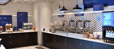 A modern breakfast area with a counter, kettles, and a sign for 'EXPRESS START BREAKFAST'.