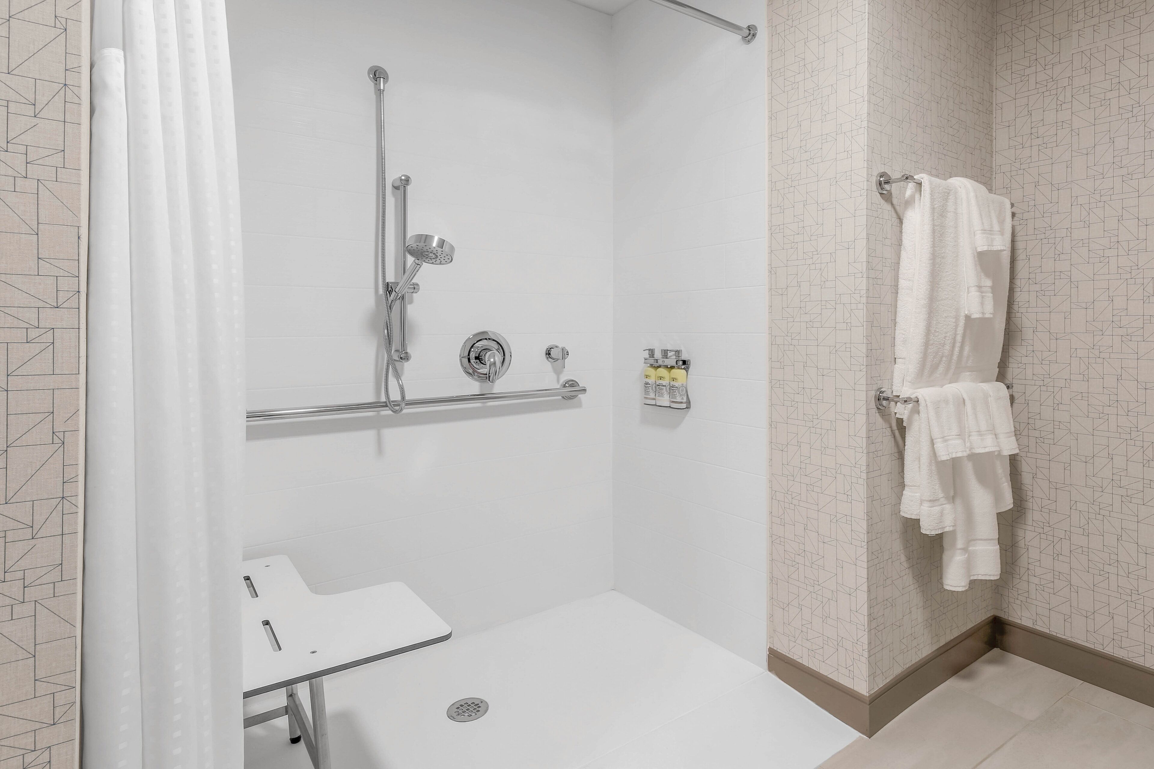 suite, 1 king bed, mobility accessible (roll-in shower) | bathroom | designer toiletries, hair dryer, towels, soap