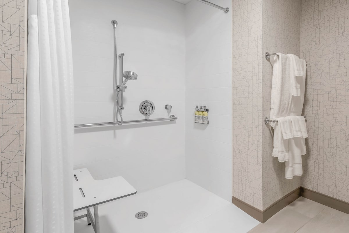 suite, 1 king bed, mobility accessible (roll-in shower) | bathroom | designer toiletries, hair dryer, towels, soap