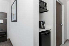 A modern kitchen with a microwave, coffee maker, and dishwasher. - Holiday Inn Express & Suites Chicago O'Hare Airport by IHG (Des Plaines)