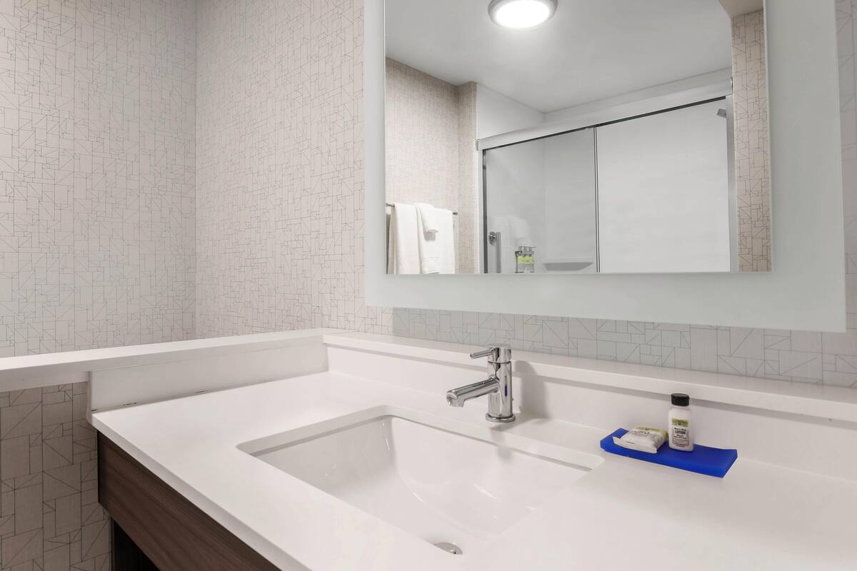 Bathroom | Designer toiletries, hair dryer, towels, soap