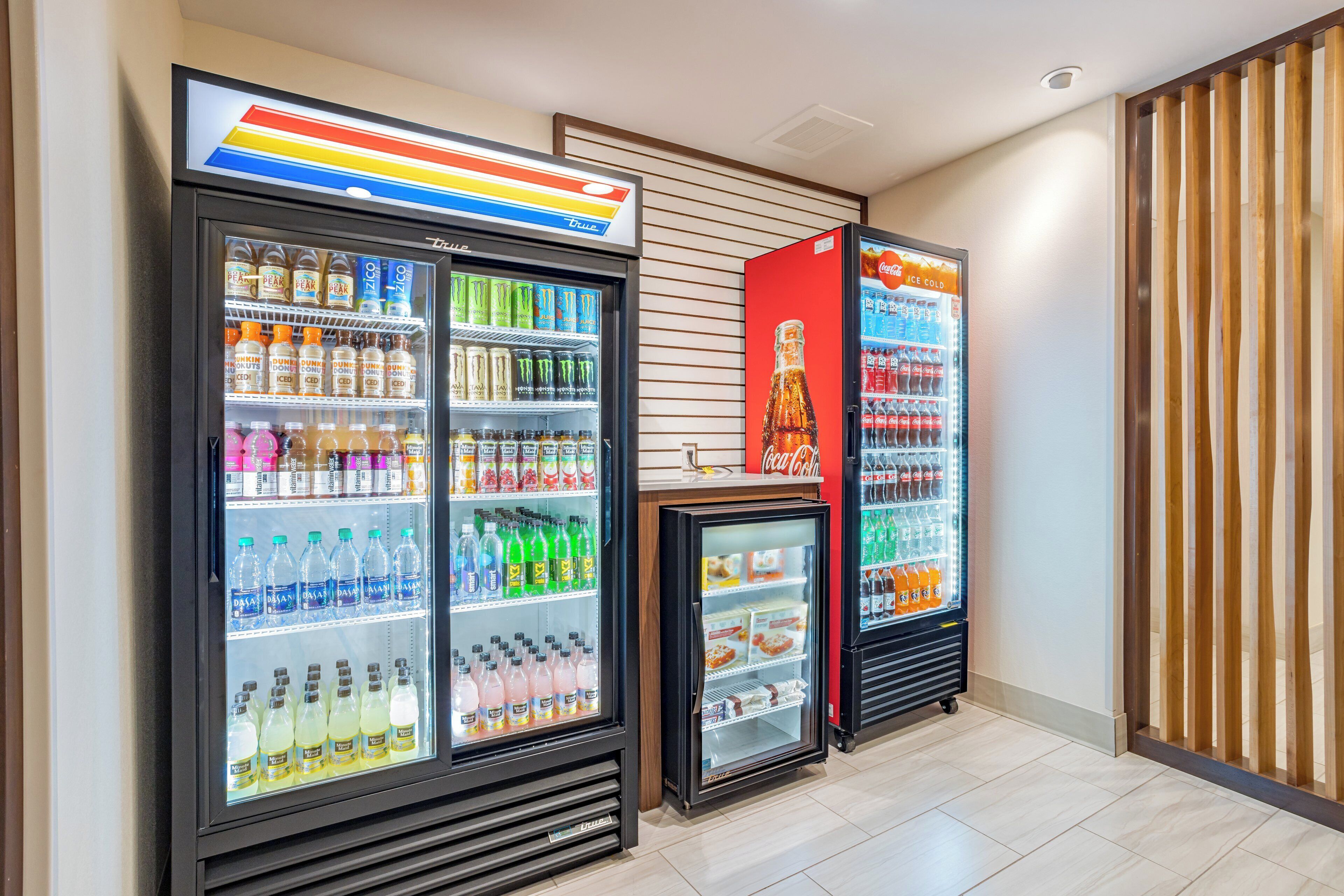 A row of beverage vending machines with various drink options.