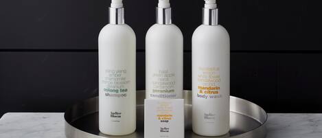Three bottles of body wash on a tray.