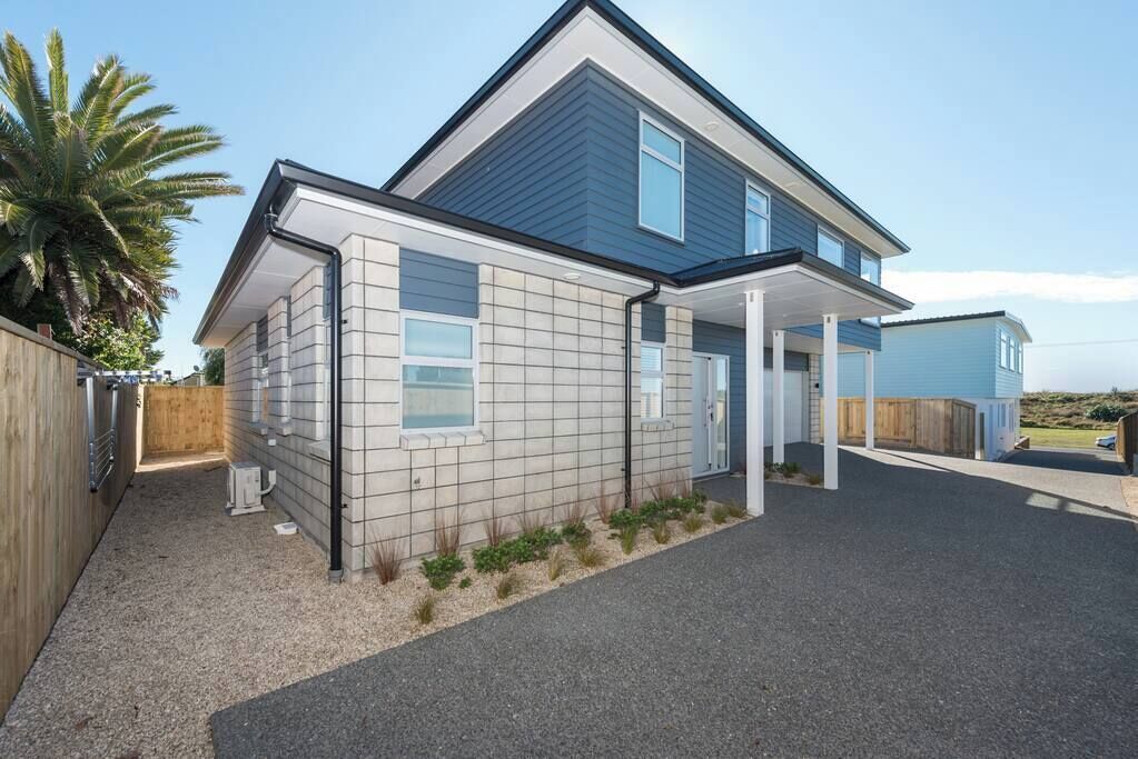 A modern two-story house with a covered porch and a garage.