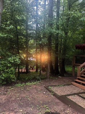 A forested area with a wooden deck and a staircase leading up. - Majestic, private cabin with hot tub/multiple deck...a little taste of heaven! (Dahlonega)