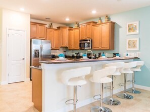 Stovetop, dishwasher, cookware/dishes/utensils - 9BR Pool Home in ChampionsGate (Davenport)