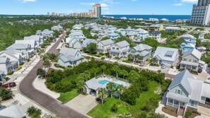 A residential area with houses, a swimming pool, and a view of the ocean. - Sleeps 8 ! Spacious 5 bedrooms 5baths (Orange Beach)