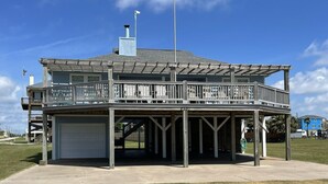 A two-story building with a covered deck and a garage. - PORTKEY - 2nd Row, Beach view, 4 bedroom, Sleeps 12 (Crystal Beach)