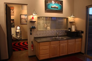 Main Room with sink, looking into Bedroom. Microwave, Airfryer, Toaster Oven.