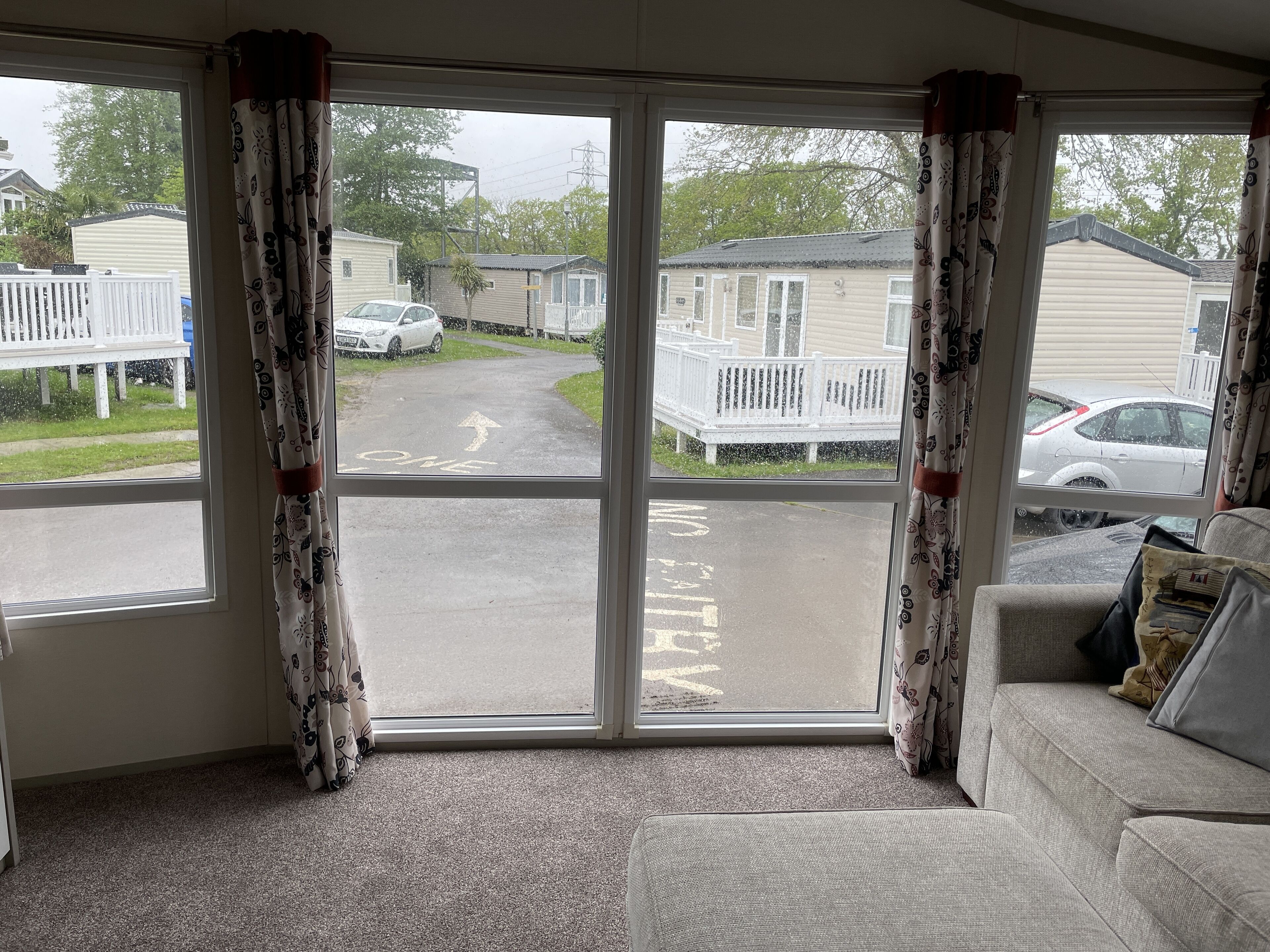 A room with a large window overlooking a street.