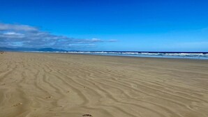 A beach with a clear sky and ocean waves.