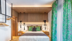 A modern bedroom with a bed, two bedside tables, and a hanging light fixture. - Ivoni Villa, Spacious Family Retreat • Pool & Play (Perama)