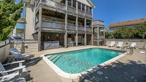 A two-story building with a swimming pool, outdoor seating, and a hot tub. - Summer Place | 325 ft from the beach | Private Pool, Hot Tub | Southern Shores (Southern Shores)