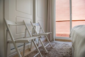 A room with a bed, a white wall, a window with curtains, and a carpeted floor. - Santa Maria, Marbella | Charming 2-Level Penthouse with Terraces, BBQ & Mediterranean Views in Marbella (Marbella)