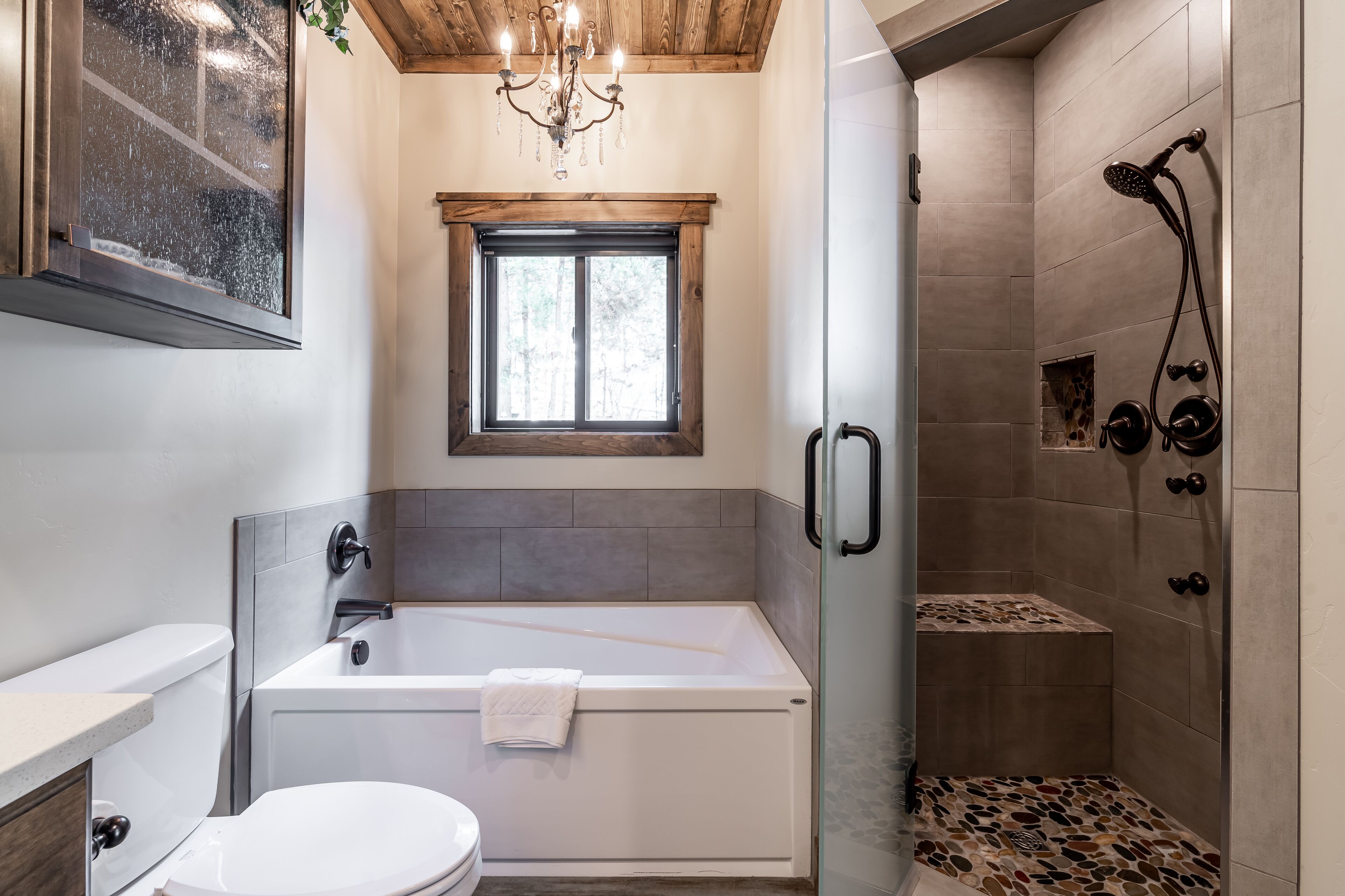 A modern bathroom with a bathtub, toilet, and shower area.