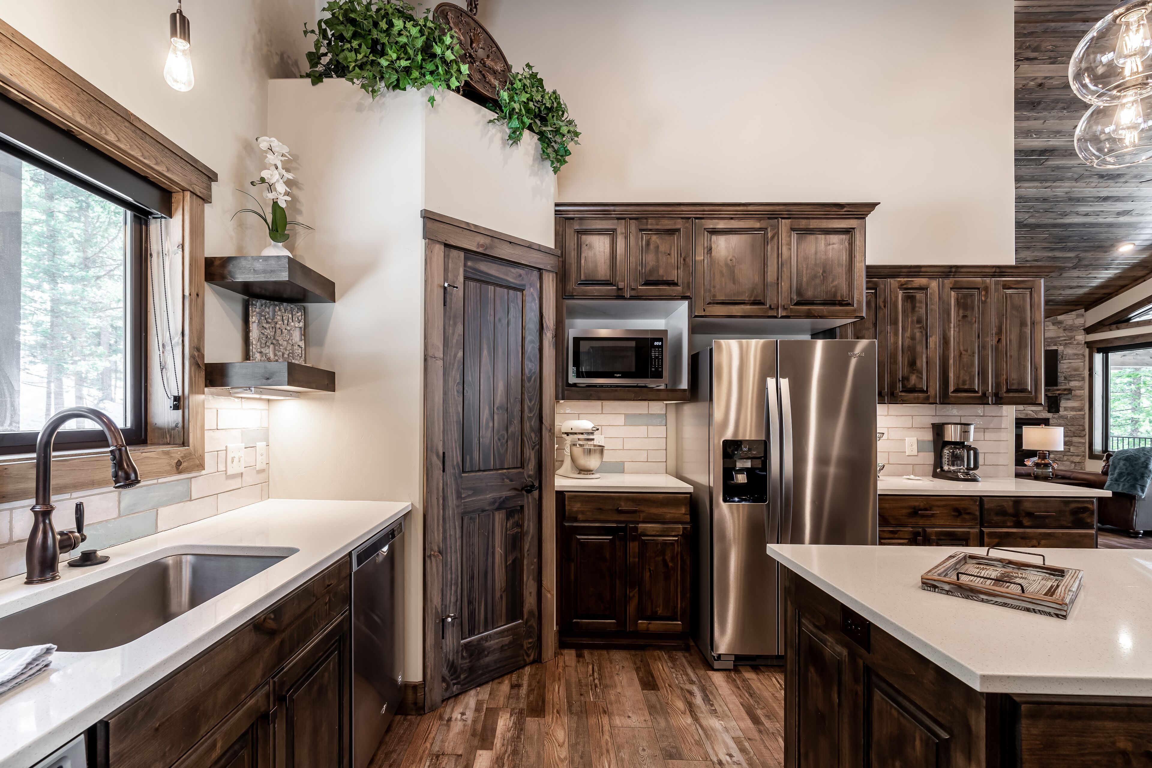 A modern kitchen with wooden cabinets, stainless steel appliances, and a large island.