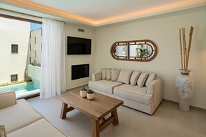 A modern living room with a sofa, coffee table, TV, and a large mirror.