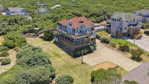 A residential area with houses, a swimming pool, and a well-maintained lawn. - Five Lucky Ducks | 400 ft from the beach | Dog Friendly, Private Pool, Hot Tub | Duck (Duck)