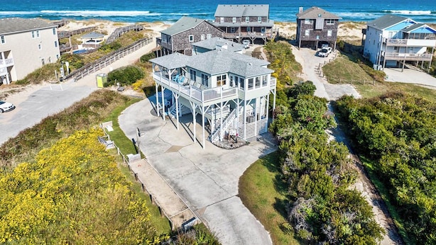 A coastal residential area with houses, a beach, and a clear view of the ocean. - No Wake Zone | 164 ft from the beach | Dog Friendly, Hot Tub | Nags Head (Nags Head)