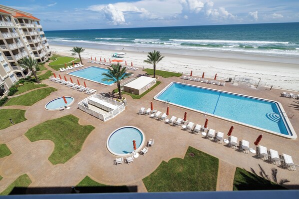 A resort with multiple swimming pools, beach access, and a view of the ocean.