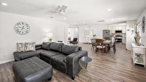 A modern living room with a sectional sofa, a dining area, and a kitchen in the background. - Gilbert Home, Walk to Downtown, Restaurants, Nightlife 10+ location! (Gilbert)