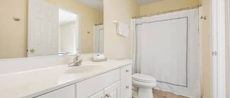 Combined shower/bathtub, towels, soap, toilet paper