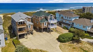 A coastal residential area with houses, a beach, and ocean views. - Sweet Isabel | Oceanfront | Private Pool, Hot Tub | Nags Head (Nags Head)