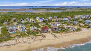 A coastal residential area with houses, a beach, and a view of the ocean. - The Porch Life | Oceanfront | Hot Tub | Nags Head (Nags Head)